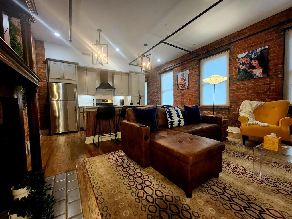 a living room with a couch and a kitchen at Easy Access I TQL Stadium I Free Parking in Cincinnati
