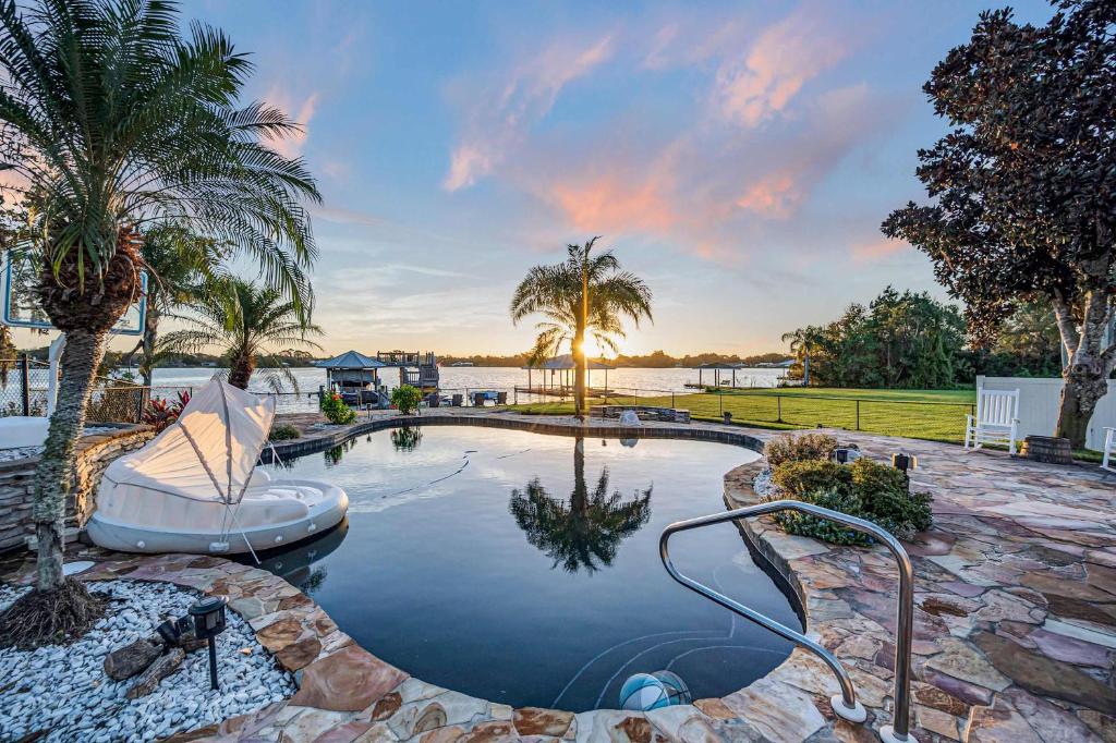 a swimming pool with a lazy river and palm trees at 5Br Sleeps 16 Private Pool-Dog Friendly-Fire Pit in Lake Placid