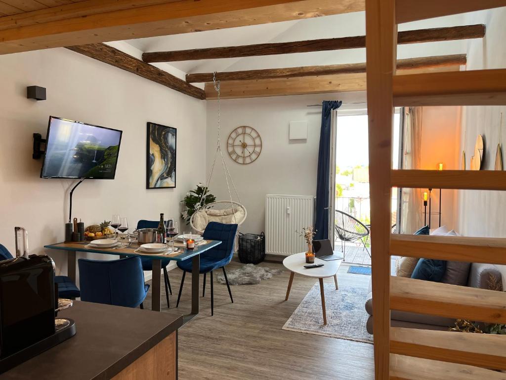 a kitchen and living room with a table and chairs at BEYOND Staying Apartments Passau in Passau