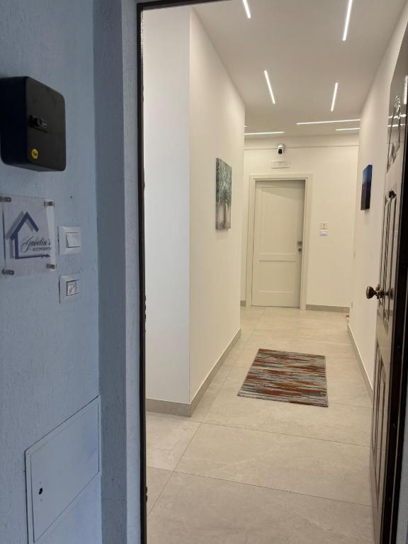 a hallway with a door and a tile floor at Javelin's Accomodation in Tropea