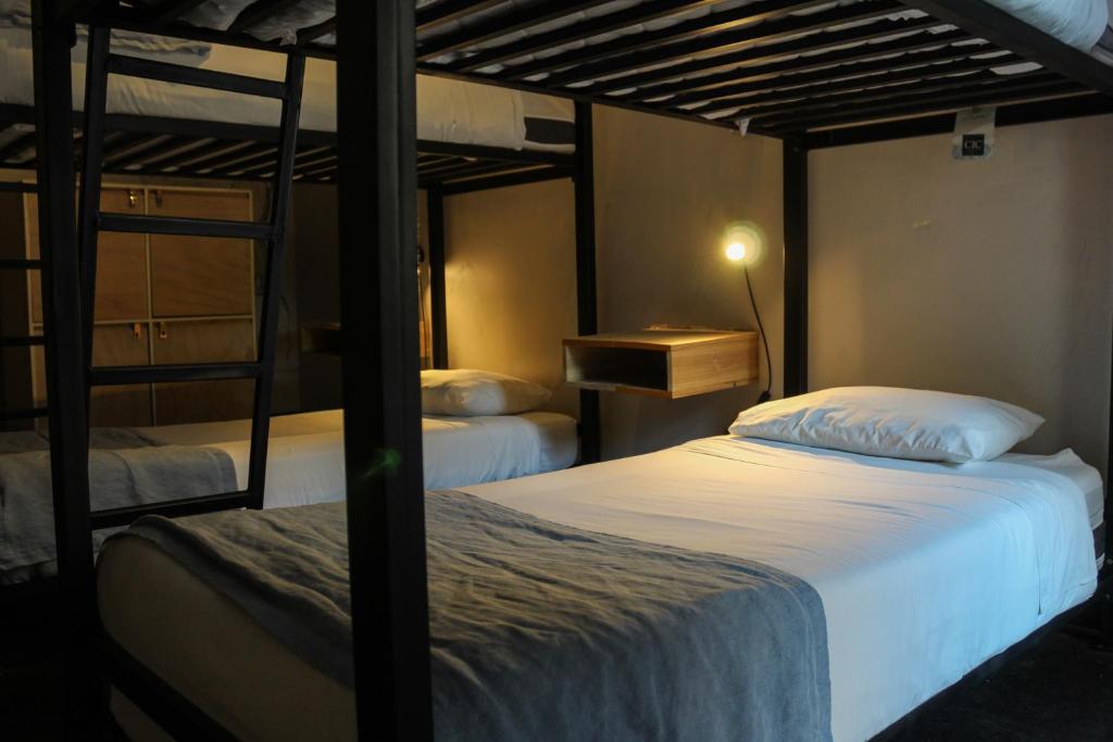 Voodi või voodid majutusasutuse Hostel Boutique Merced 88 toas