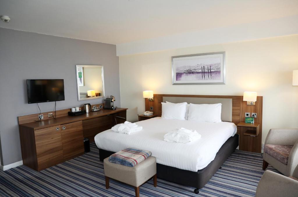 a hotel room with a bed and a television at Holiday Inn Brighton Seafront by IHG in Brighton & Hove