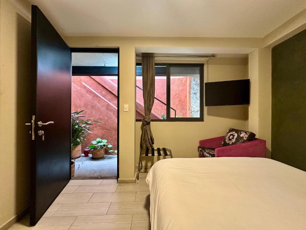 Postel nebo postele na pokoji v ubytování Casa Bakora Hotel