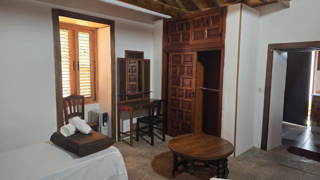 a bedroom with a bed and a chair and a desk at Los Frailes 28 in Fátaga