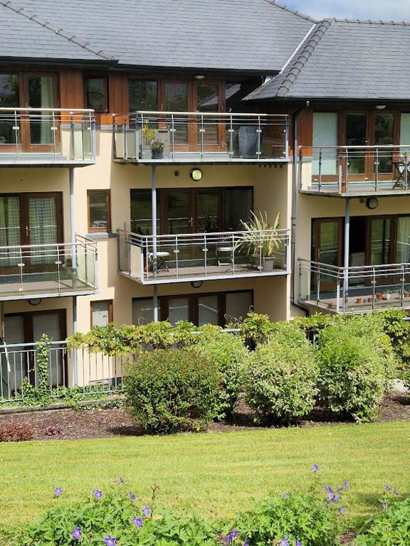 a large apartment building with balconies and a yard at Westport luxury apartment Knockranny in Westport