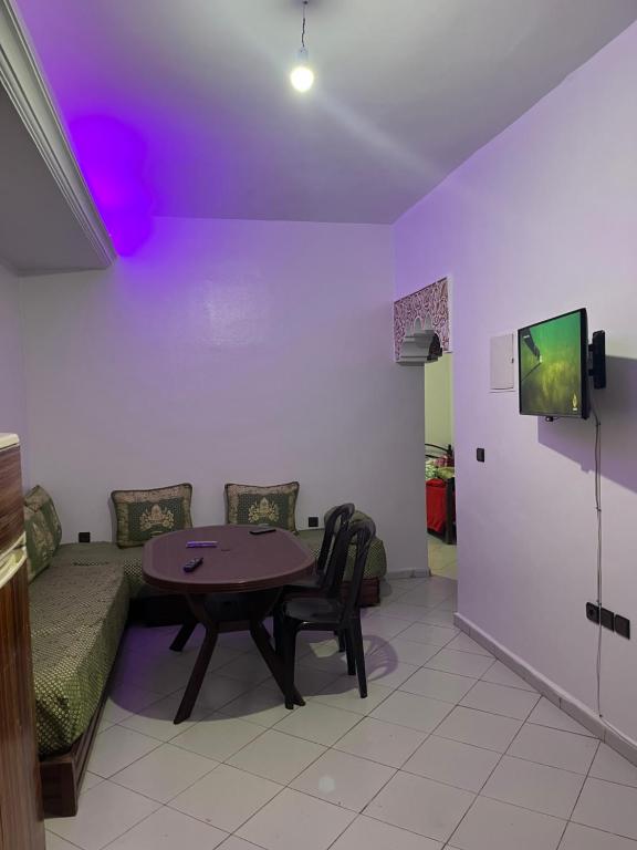 a living room with a table and a couch at Rihane housse in Essaouira