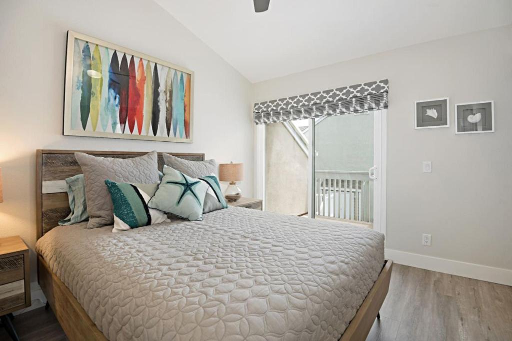 een slaapkamer met een groot bed en een raam bij Chic Upstairs Condo Steps from Strands Beach in Dana Point