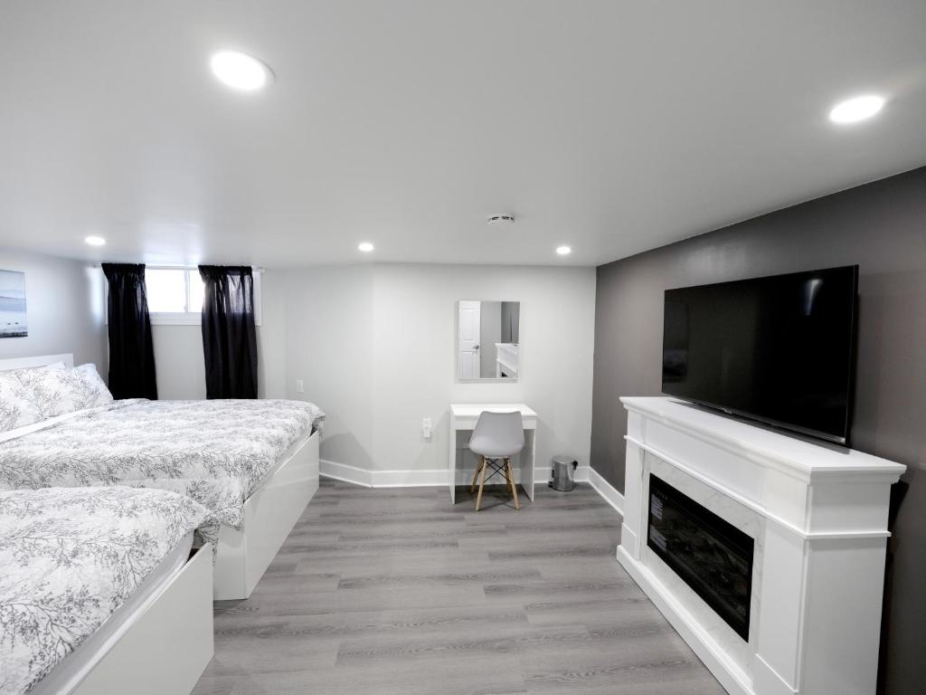 a bedroom with a bed and a flat screen tv at Serene Niagara Inn in Niagara Falls