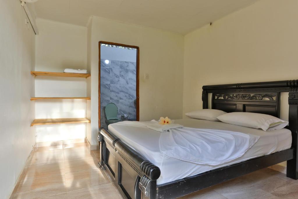 Postel nebo postele na pokoji v ubytování Hostal La Finquita