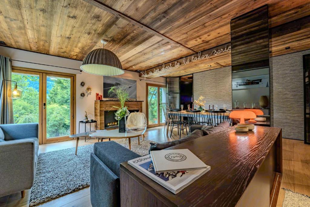 a living room with a couch and a table at Stylish 3BR Apartment with Mountain View - 8 Guests, Rochebrune, Megève in Megève