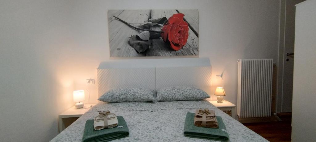 a bedroom with a bed with two slippers on it at Open Space in Bassano del Grappa