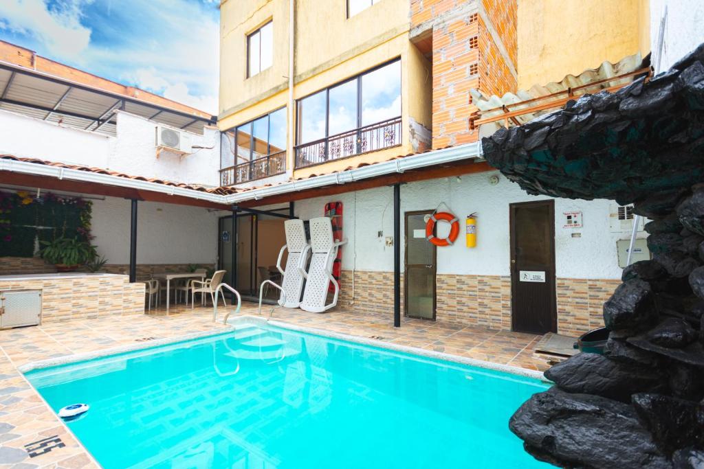 a swimming pool in front of a building at Hotel Colores Boutique in Medellín