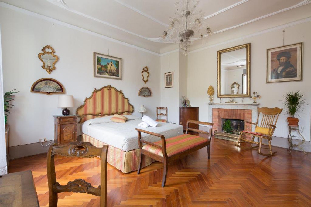 a bedroom with a bed and a fireplace at Santo Spirito Palace in Florence