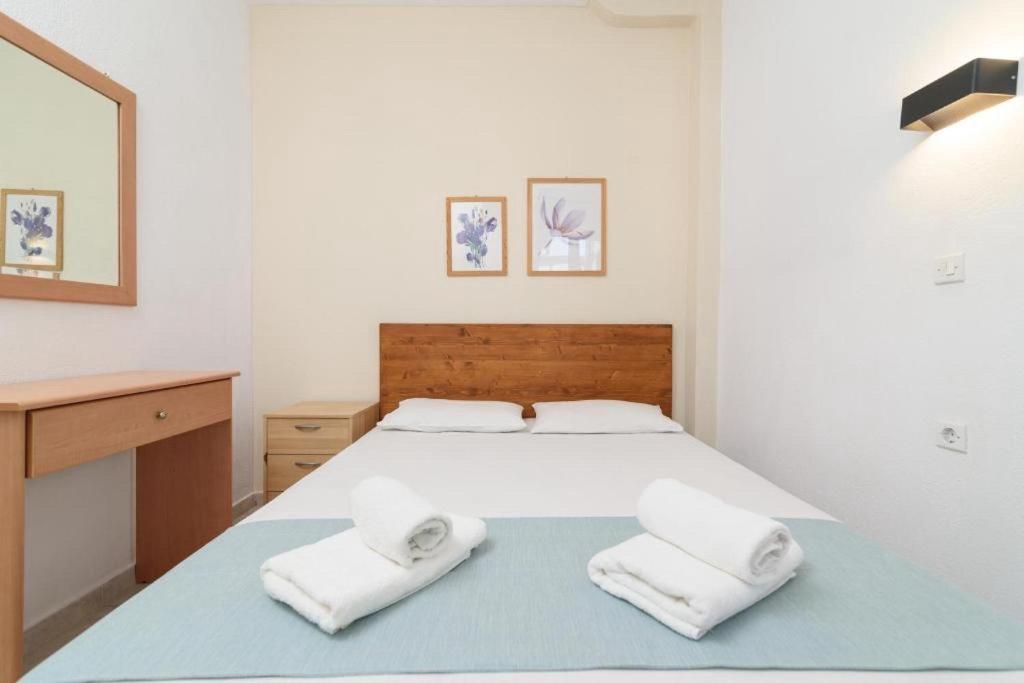 a bedroom with a bed with two towels on it at SIDI apartments in Polychrono