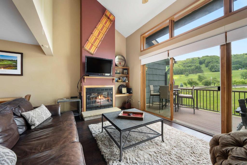 a living room with a couch and a fireplace at Walk to Lift Across from Holiday Valley AC in Ellicottville