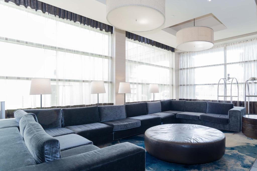 a large living room with a couch and a table at Sandman Signature Vancouver Airport Hotel & Resort in Richmond