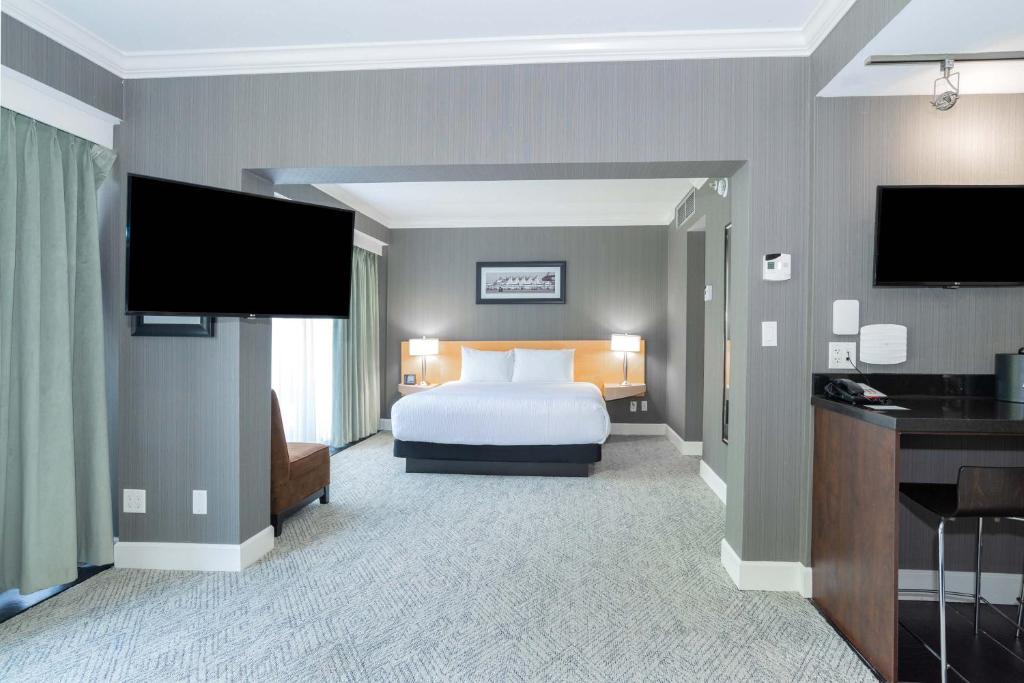 a hotel room with a bed and a flat screen tv at Sandman Signature Vancouver Airport Hotel & Resort in Richmond