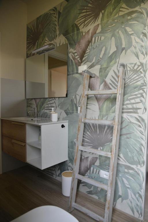 a bedroom with a bunk bed with a ladder and a mirror at Il Giardino di Eva - Holiday Home - intero alloggio in Solferino