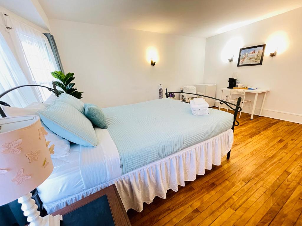 a bedroom with a bed with blue pillows at Prime and Precious location The Red House Room3 in Charlottetown