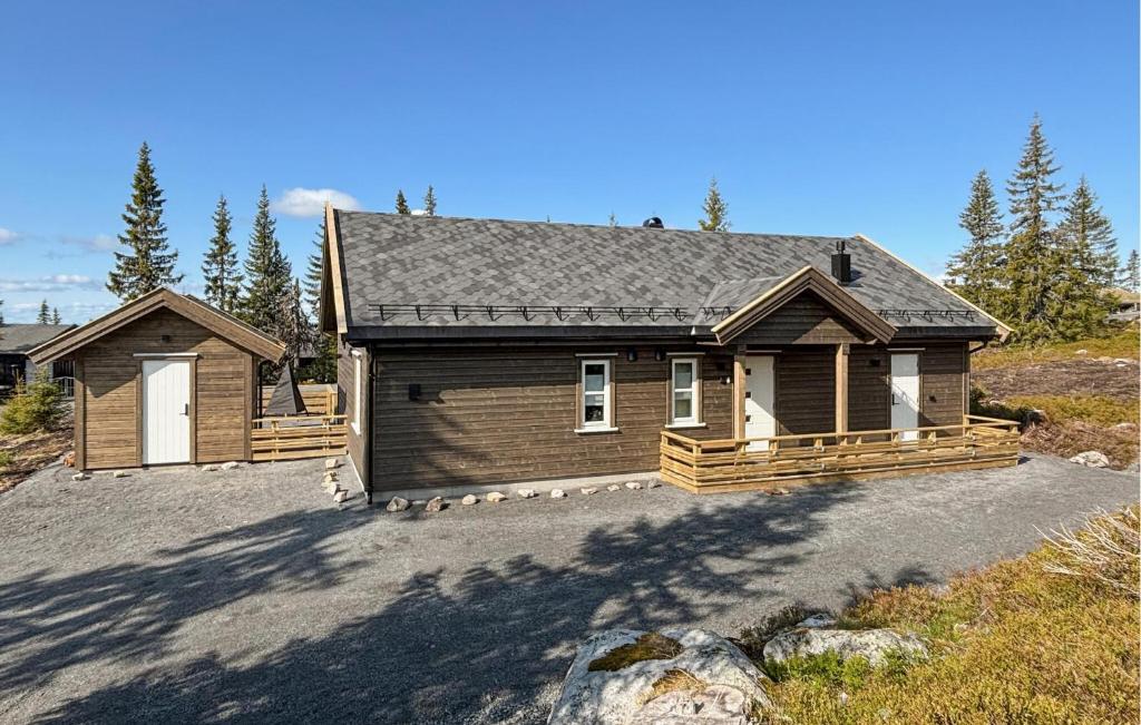 a house with a large driveway in front of it at Stunning Home In Sjusjøen With Sauna in Sjusjøen