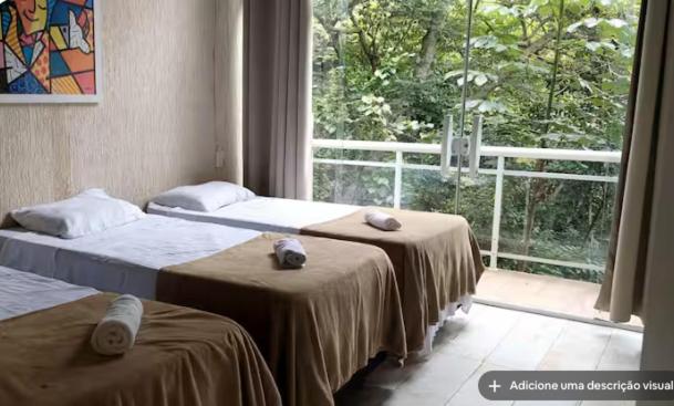 Un pat sau paturi într-o cameră la Altos da Brava Búzios Guest House