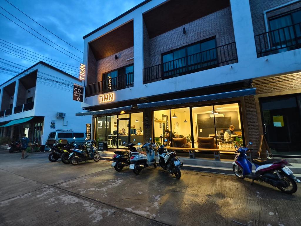 拜县TIMN Hostel Female Only的停在大楼外的一组摩托车
