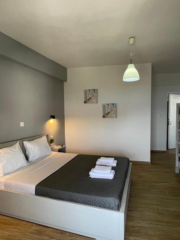 a bedroom with a bed with towels on it at Enopia Apartments Himara in Himare