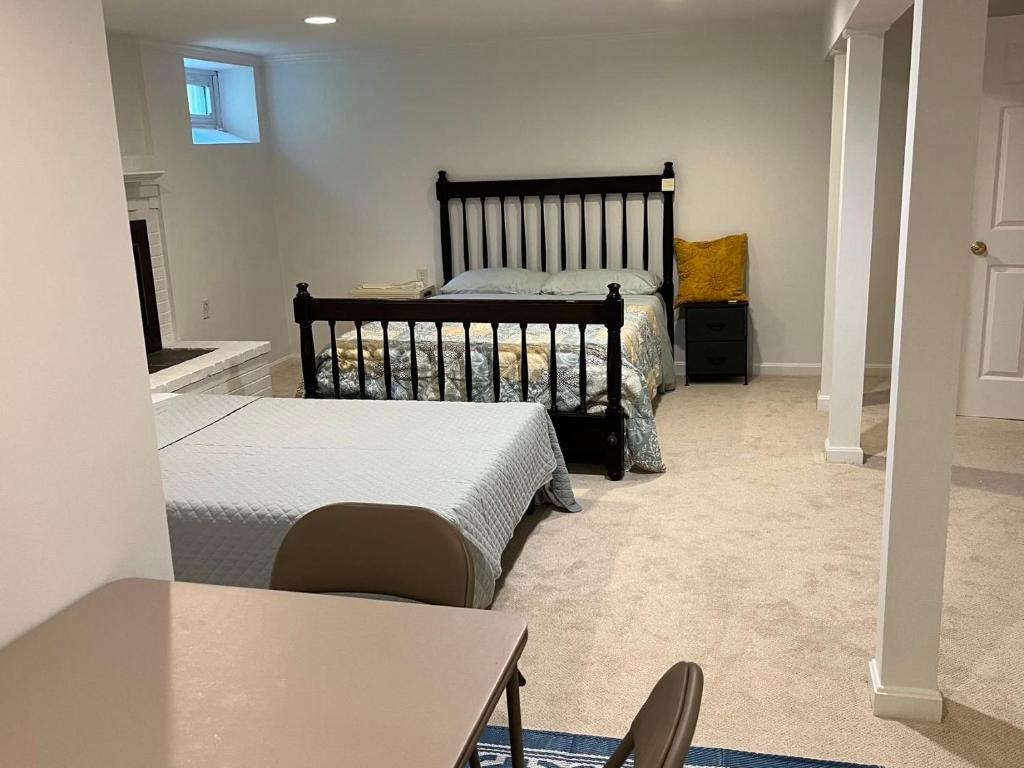 a bedroom with two beds and a table and chairs at basement Two queen beds with private bathroom in Lexington in Lexington