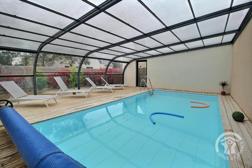 a large swimming pool with a retractable roof at Patelle in Erquy