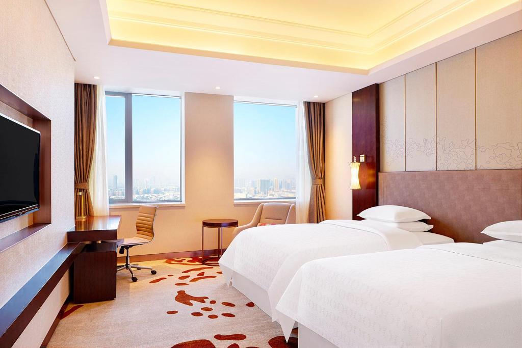 Postel nebo postele na pokoji v ubytování Sheraton Harbin Xiangfang Hotel