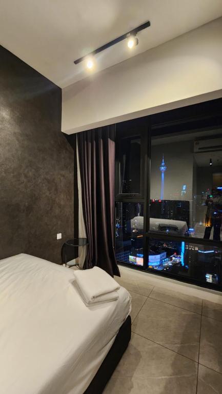 Postel nebo postele na pokoji v ubytování Axon Residence Damai Bukit Bintang