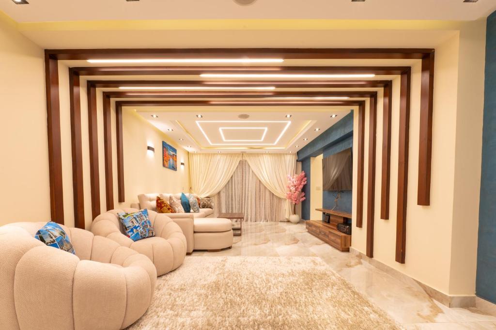 a living room with two couches and a television at Royal Heliopolis in Cairo