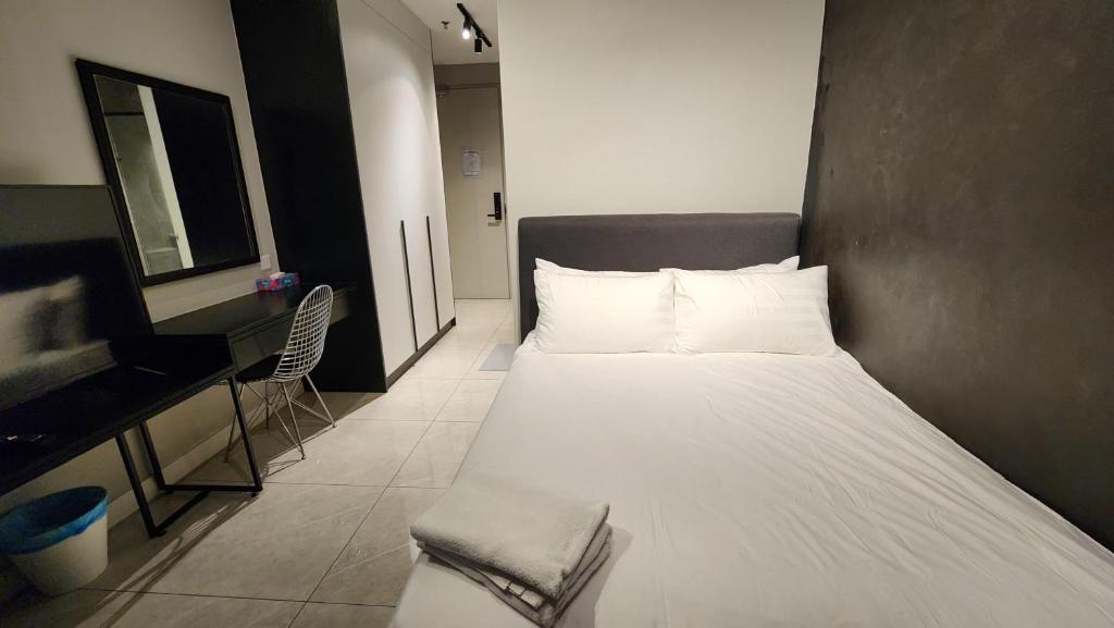 Postel nebo postele na pokoji v ubytování Axon Residence Damai Bukit Bintang