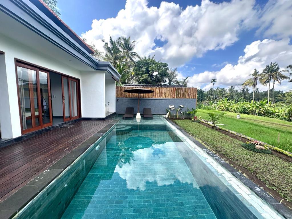 a swimming pool in the backyard of a house at Alam Dana Ubud in Ubud