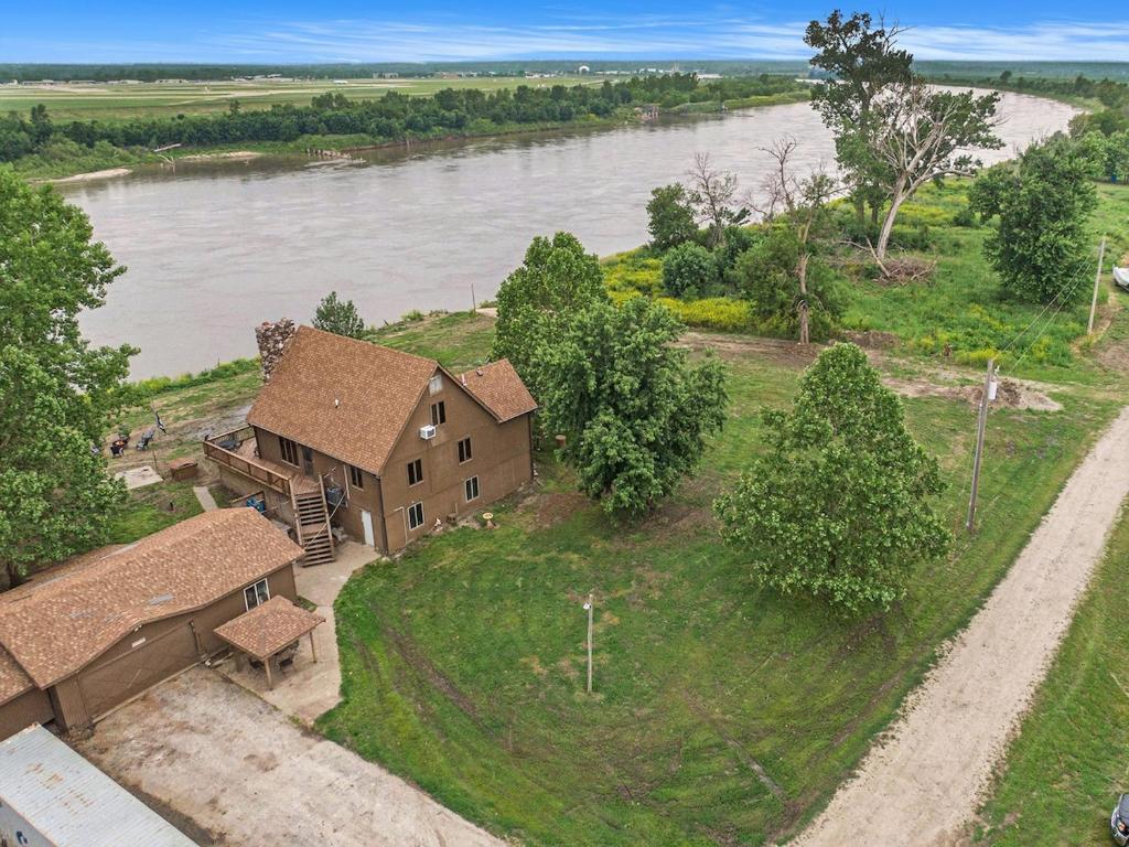 an aerial view of a house on the banks of a river at Relaxing River Cabin! 