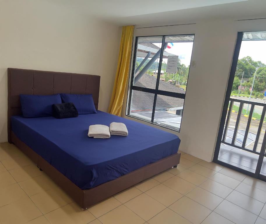Postel nebo postele na pokoji v ubytování Nucifera Hotel Tambunan