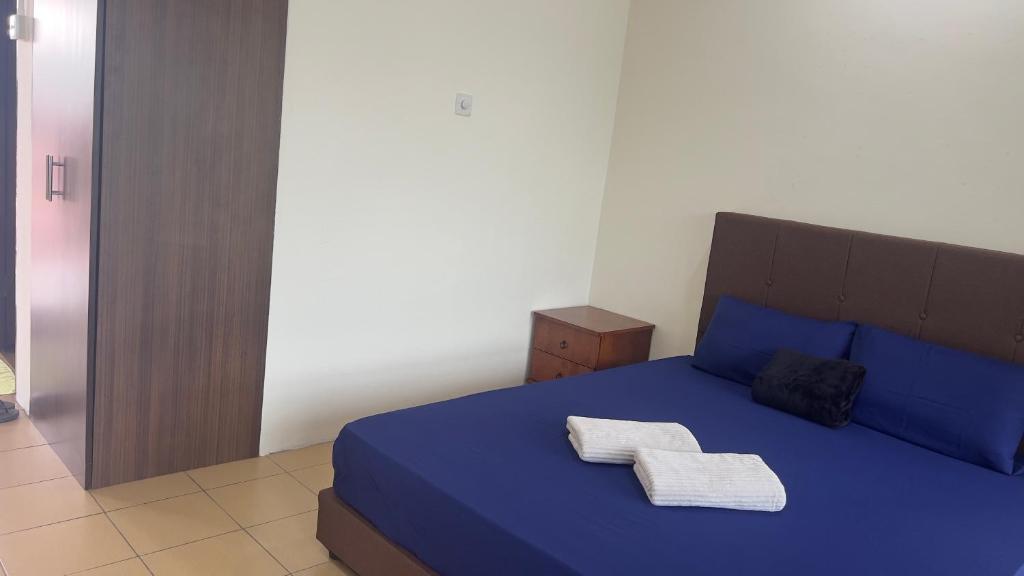 Postel nebo postele na pokoji v ubytování Nucifera Hotel Tambunan