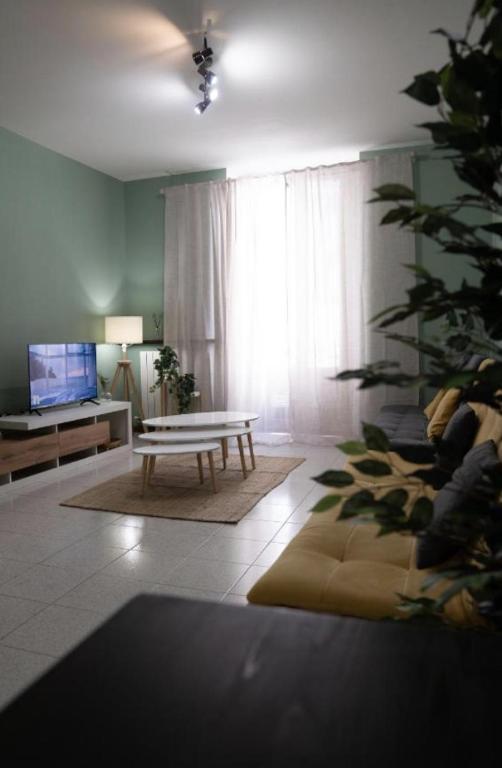 a living room with a couch and a table at ApartHotel Verona Centro - Teatro Filarmonico in Verona