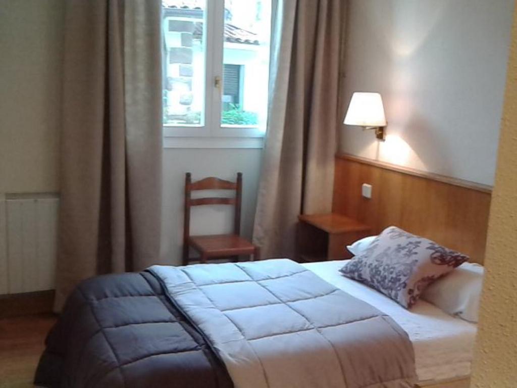Postel nebo postele na pokoji v ubytování Hotel Elizondo