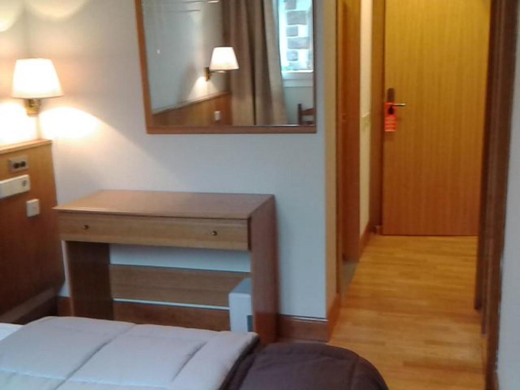 Postel nebo postele na pokoji v ubytování Hotel Elizondo
