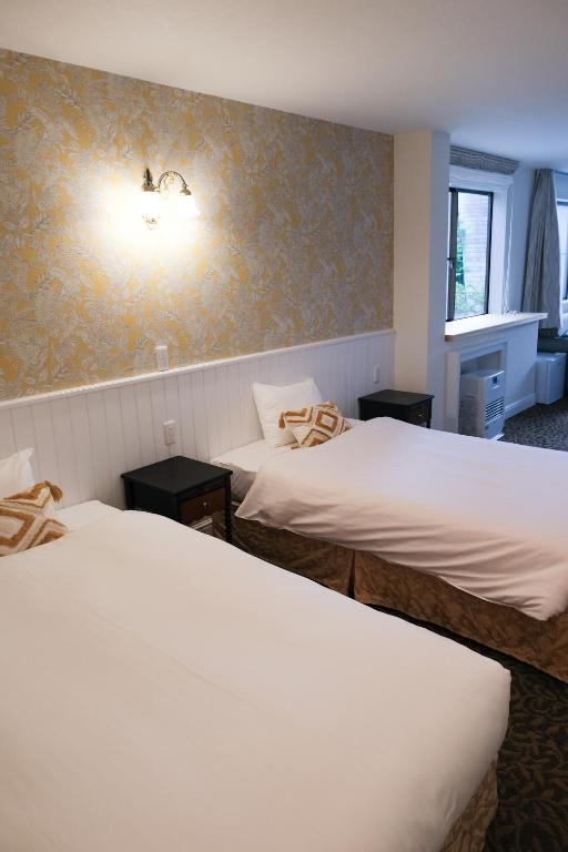 Postel nebo postele na pokoji v ubytování Hotel Wellies