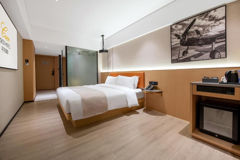 Postel nebo postele na pokoji v ubytování Guangzhou Baiyun Airport COCO Hotel