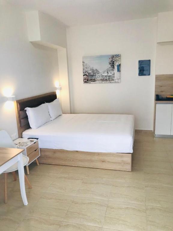 a bedroom with a large white bed in a room at Navarino Luxe Suites in Perea
