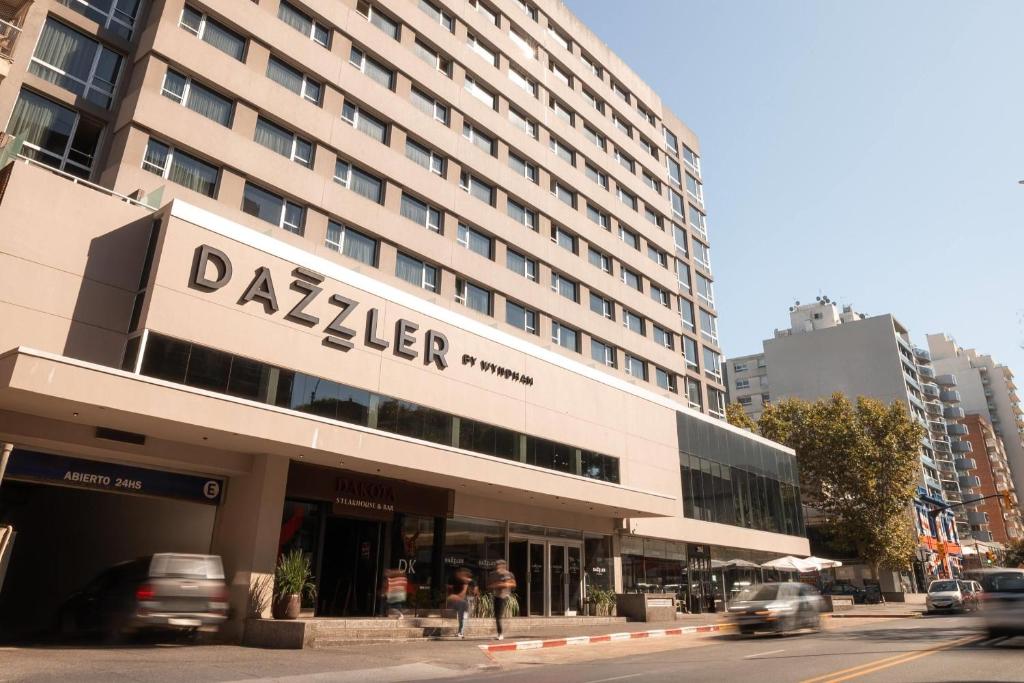 a building with a sign for a dallas hotel at Dazzler by Wyndham Montevideo in Montevideo