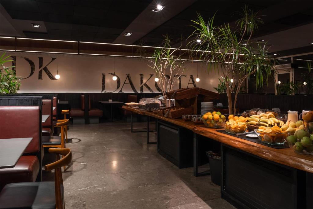 a restaurant with a counter with fruit on it at Dazzler by Wyndham Montevideo in Montevideo