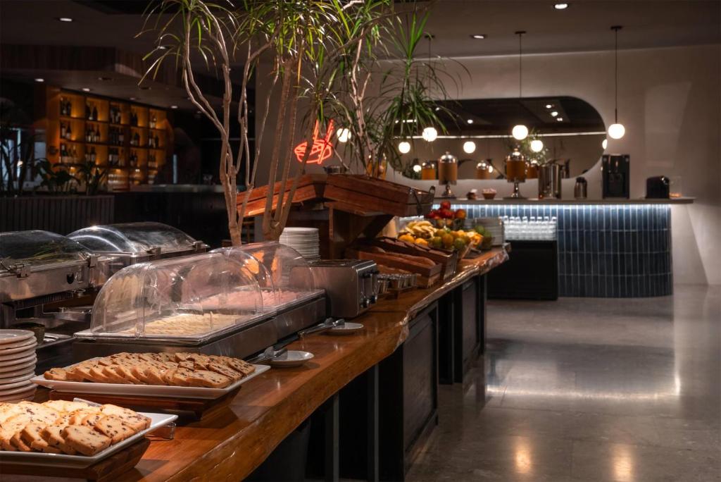 a buffet line with many different types of food at Dazzler by Wyndham Montevideo in Montevideo