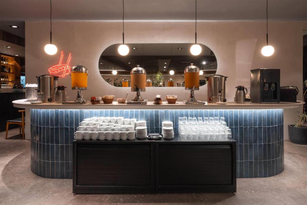 a counter with a bunch of cups on top at Dazzler by Wyndham Montevideo in Montevideo