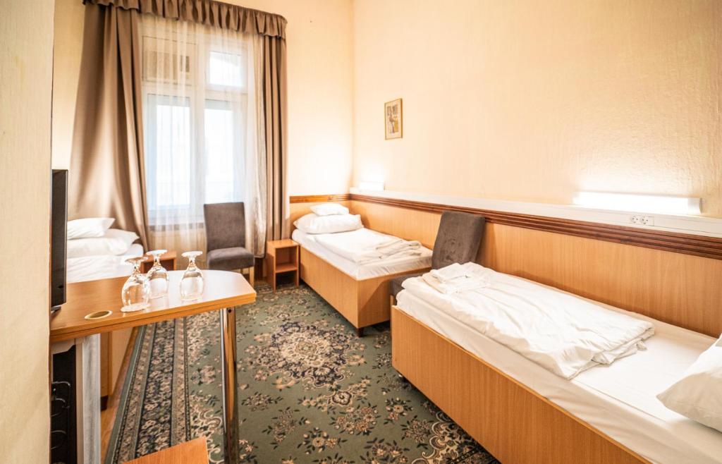 Postel nebo postele na pokoji v ubytování Tisza Hotel