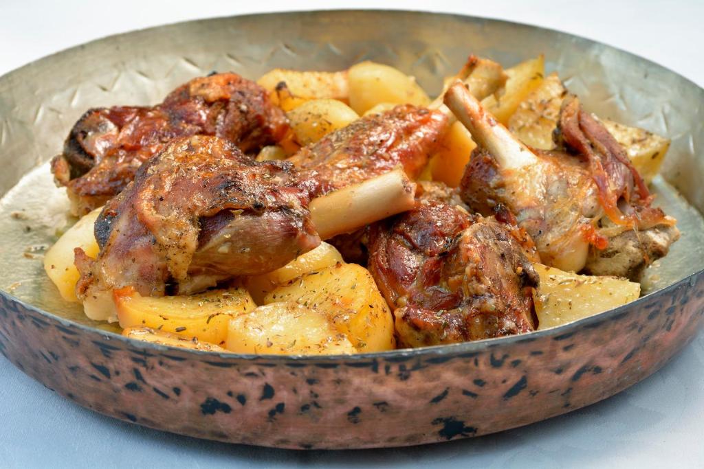 a bowl of food with meat and potatoes at Gastronomy Hotel Kritsa in Portaria