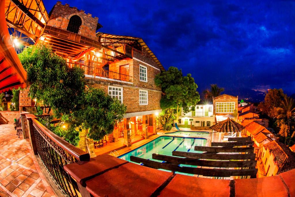 una piscina frente a un edificio por la noche en Hosteria de la Plaza Menor, en Santa Fe de Antioquia
